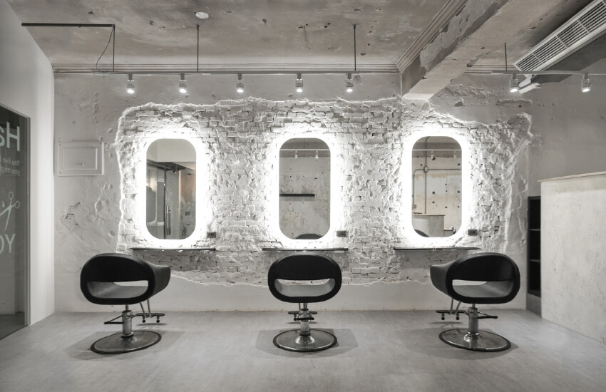 air salon’s main service area with a clean white wall and modern salon chairs