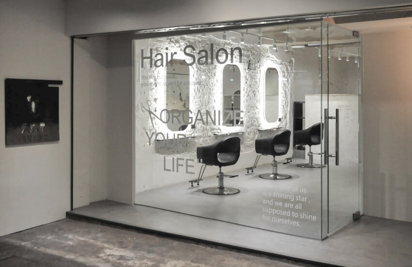 Wide-angle shot of the salon interior, showcasing the haircut stations