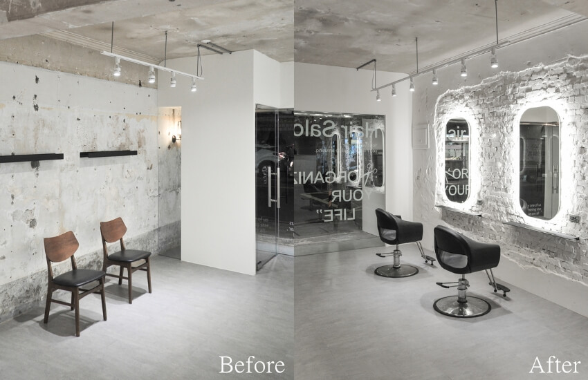 Salon waiting area featuring a distressed wall with peeling paint and exposed concrete and haricut space on the other side