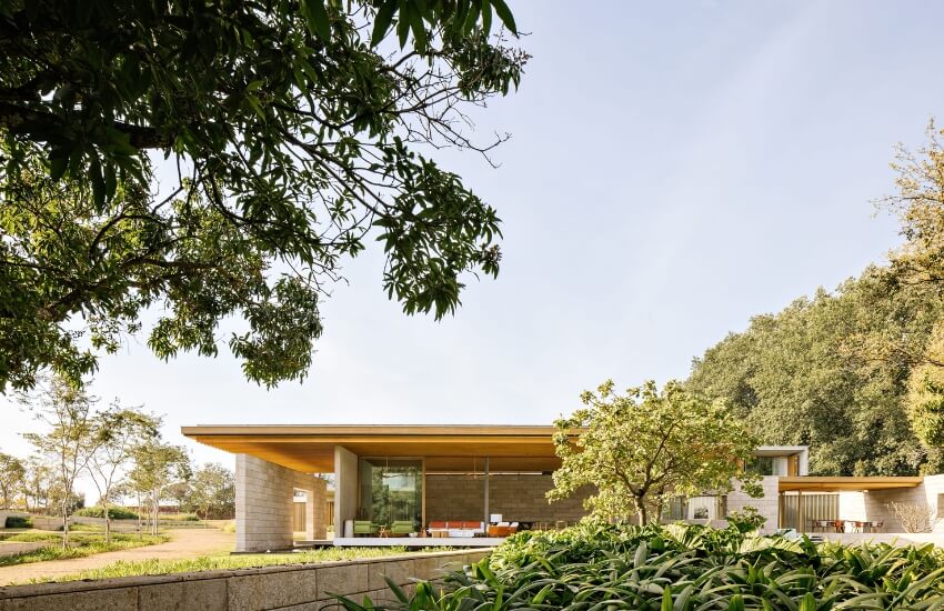 Close-up of Casa Bosque’s exterior, showing stone walls and lush greenery