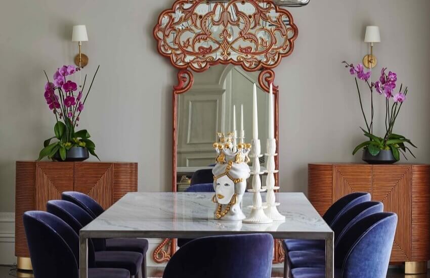 Contemporary dining room with neutral tones, statement lighting, and art from the client’s collection