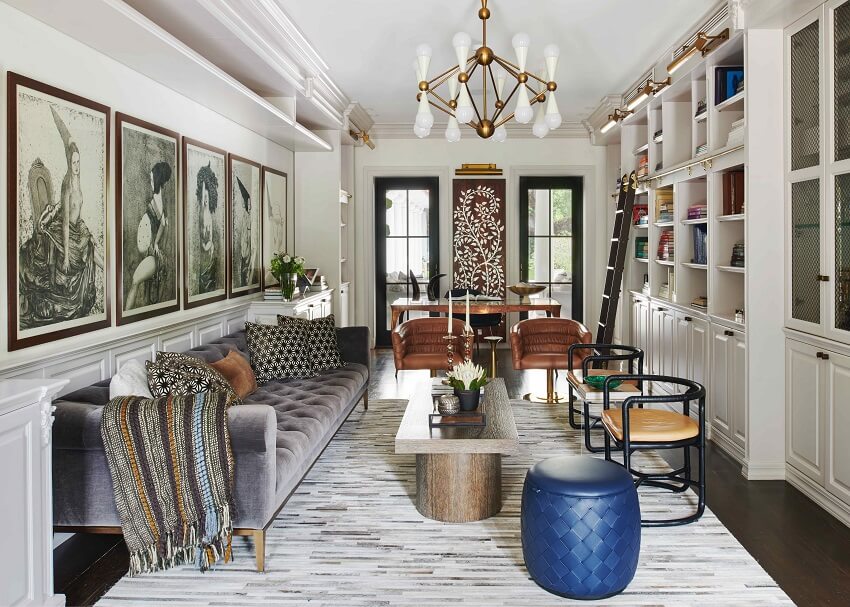 Interior living room featuring neutral hues, a wood-paneled mantlepiece, and curated art pieces