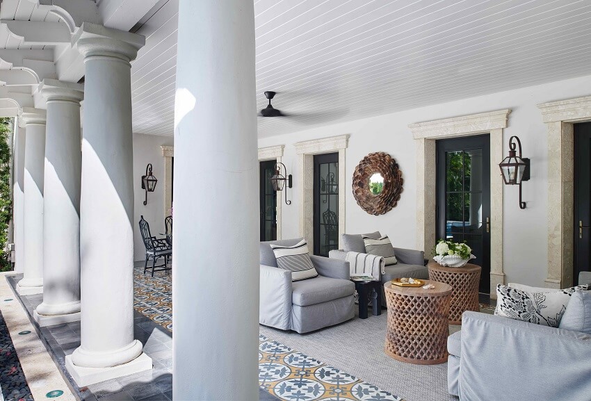 Outdoor seating area by the pool with modern furniture and lush landscaping