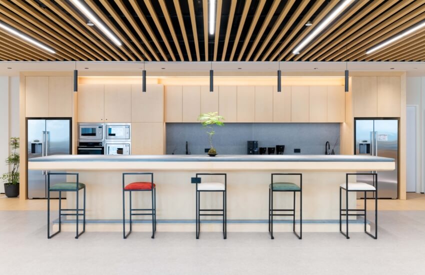 Modern office kitchen and communal dining area designed with sustainable materials