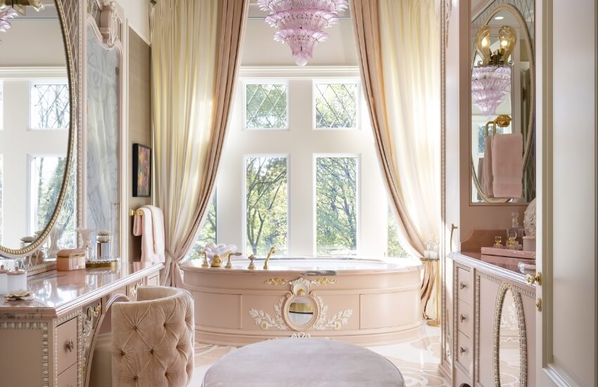 Spa-like bathroom showcasing marble surfaces, gilded fixtures, and a freestanding tub