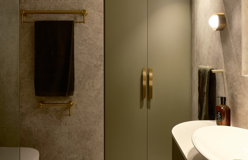 Contemporary bathroom featuring curved bulkheads, neutral tiling, and minimalistic fixtures