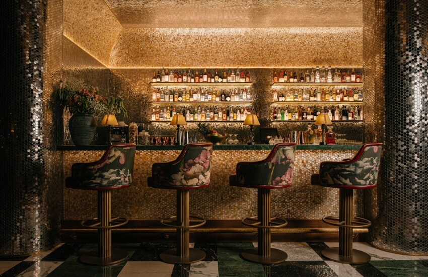 Bar area at Obica Restaurant and Lounge featuring burgundy tones and soft lighting