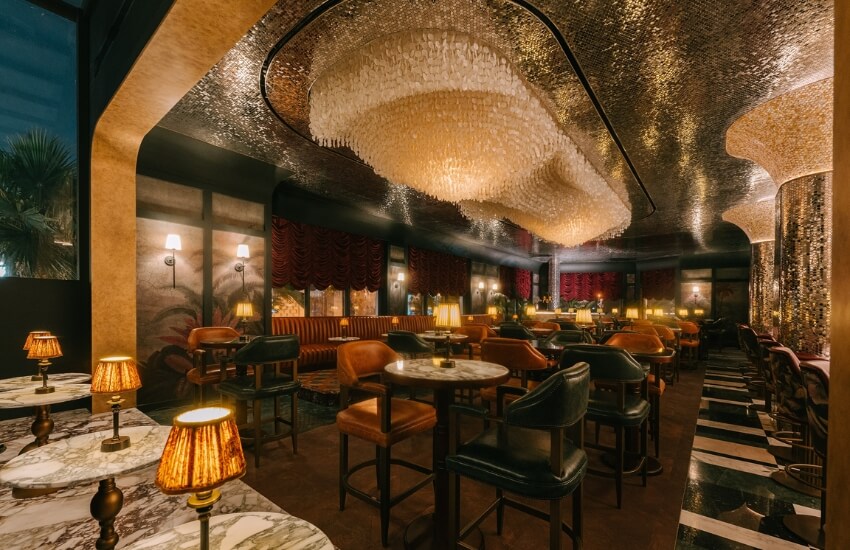 Bright view of Obica Restaurant dining hall with marble flooring and emerald green accents