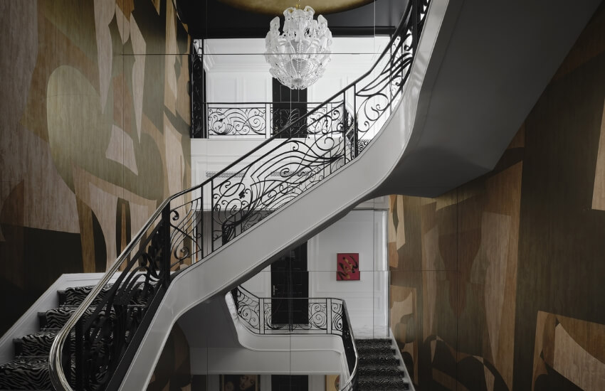 Sculptural staircase with integrated wall art and refined material detailing