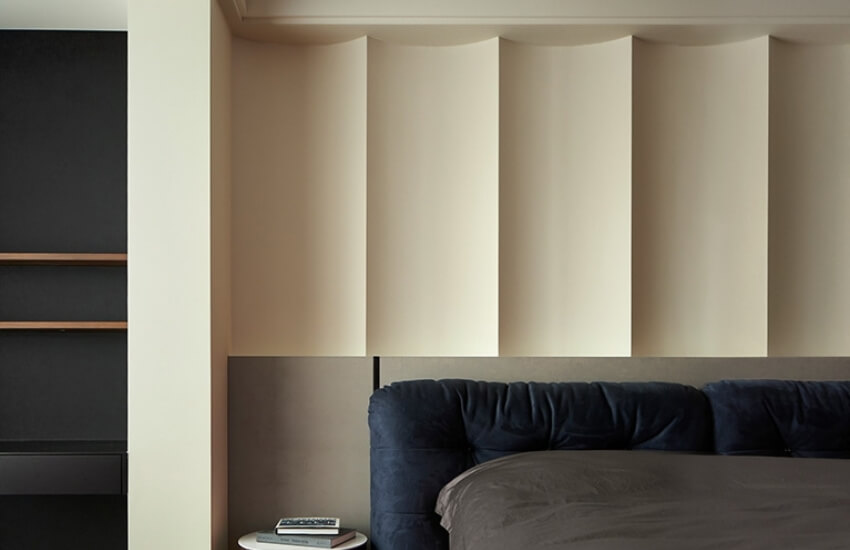 Textured bedroom wall with sculpted detailing and soft tones