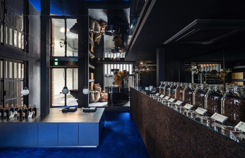 Interior view of Poppy Roastery in Nagoya with low aluminum ceiling and blue carpet