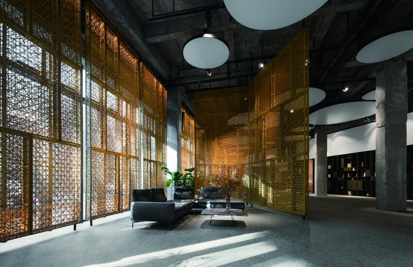 Lounge area with perforated metal screens and natural light at MWH Life style Center