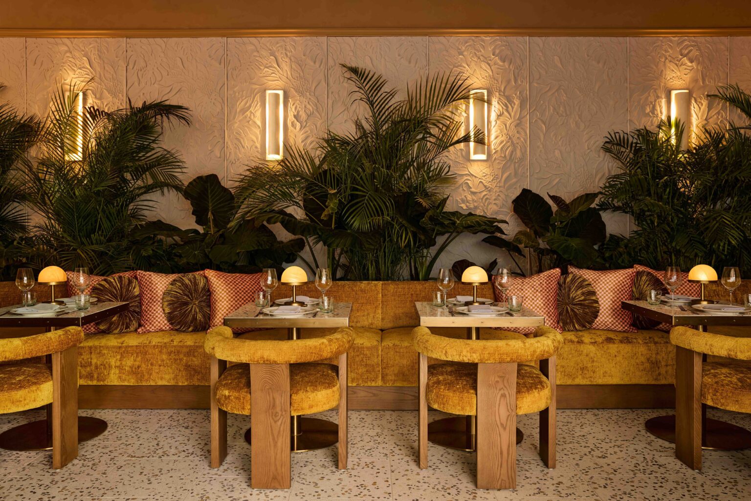 Cafe Goldie interior with golden hues and velvet seating