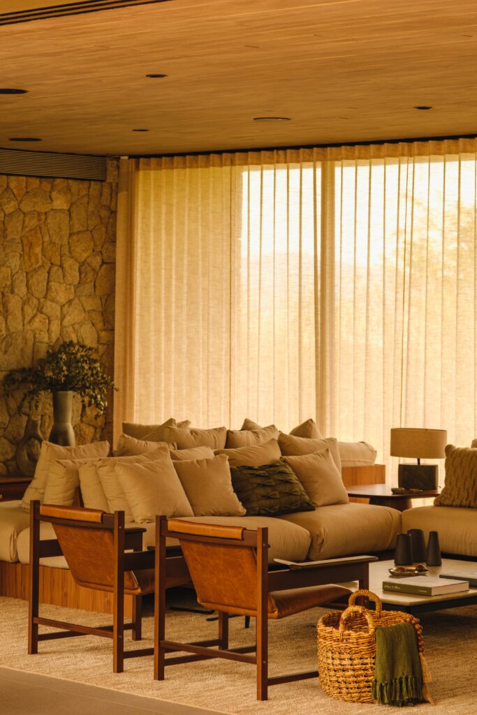 Interior living area with mid-century Brazilian furniture and concrete walls
